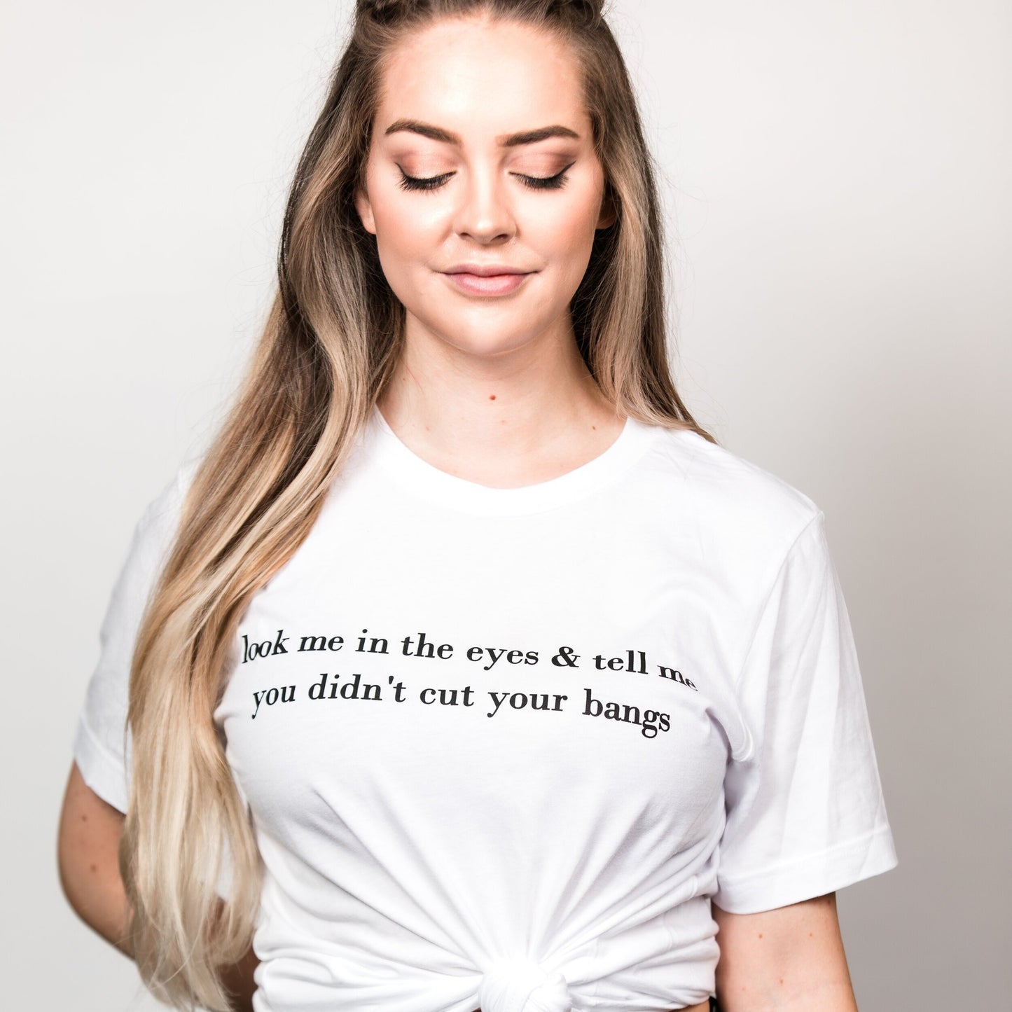 Salon & Hair Humor boyfriend t-shirt style. Comfortable & breathable cotton material. Perfect fit as a casual unisex tee or to dress up with a blazer styled look.Look Me in the Eyes & Tell Me You Didn't Cut your Bangs Graphic T-Shirt